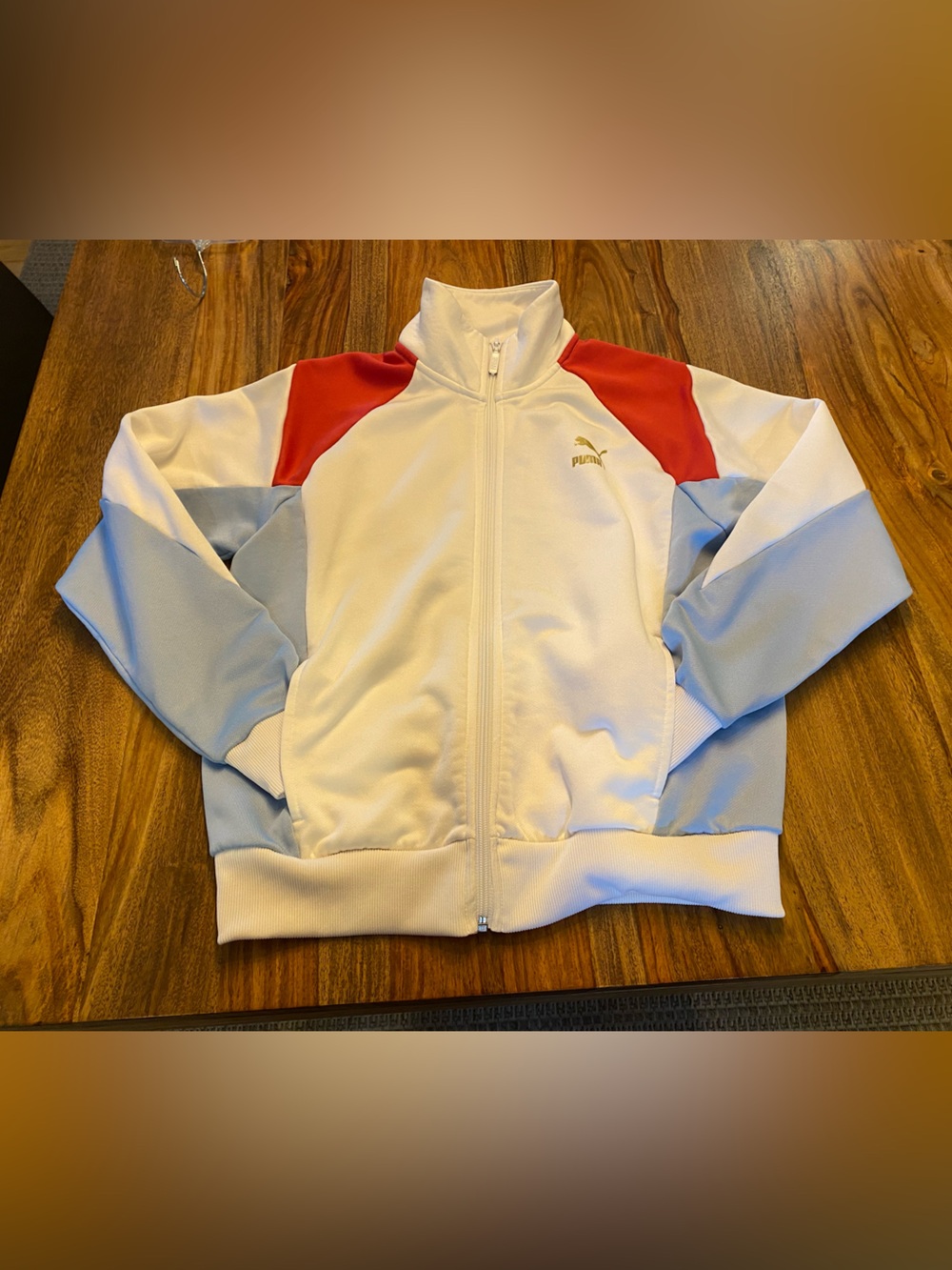 Puma women’s White Colorblock Track Jacket with Red & Light Blue Panels.